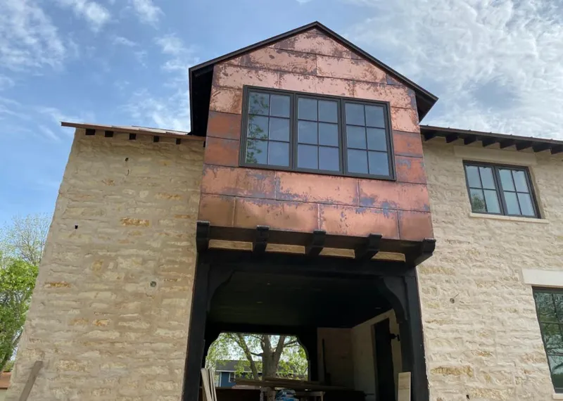 Copper metal panel facade on a stone building for Skylight Installation in Pueblo